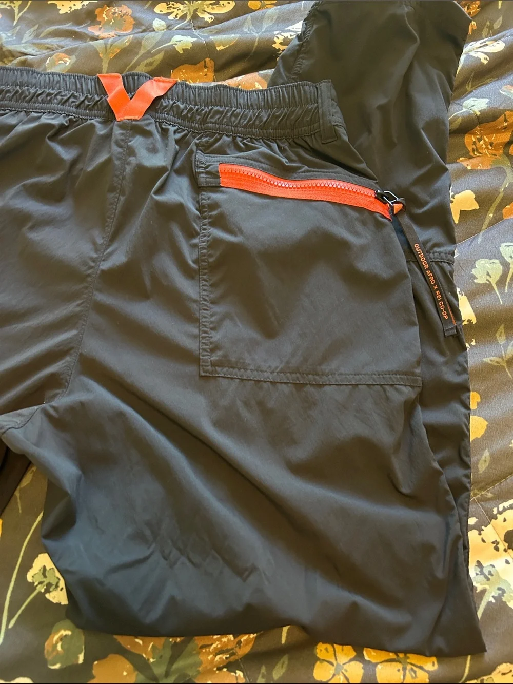 REI Men's Black Outdoor Softshell Pants with Orange Zip Accents